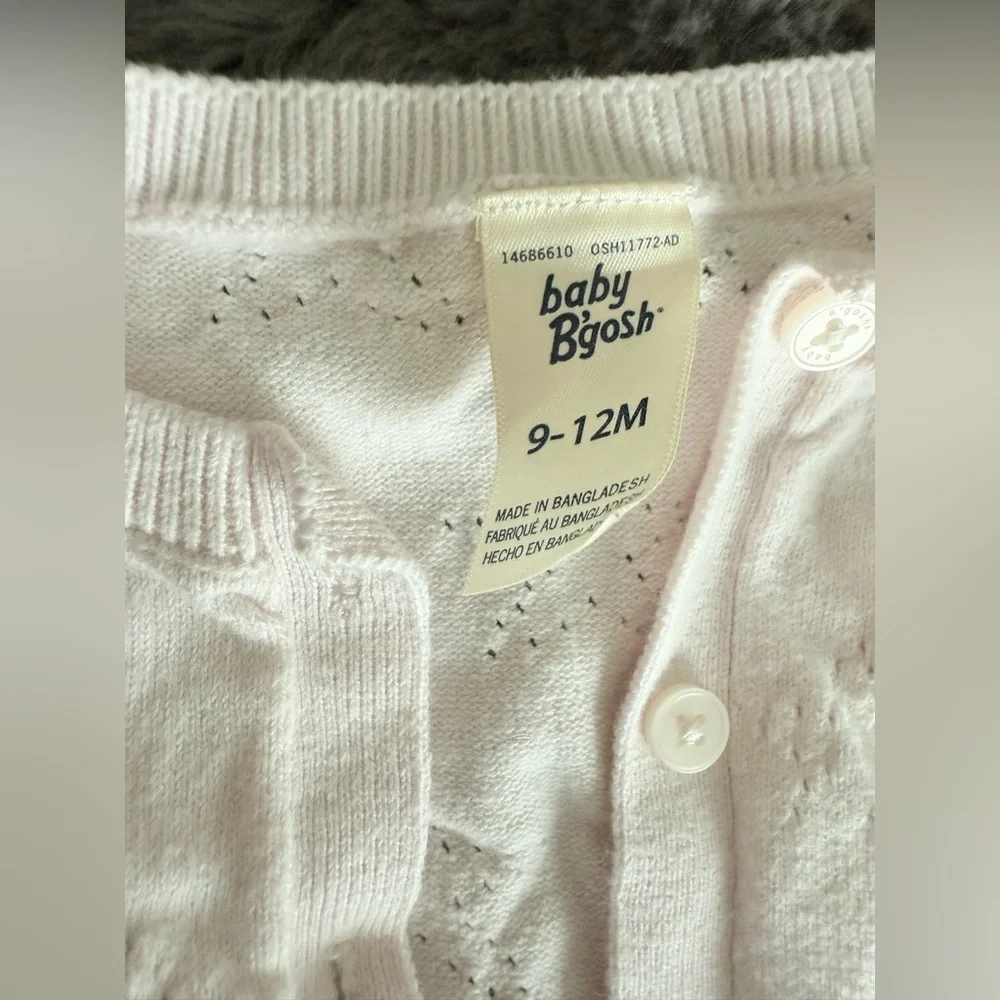Light pink cardigan size 9-12M has a faint stain